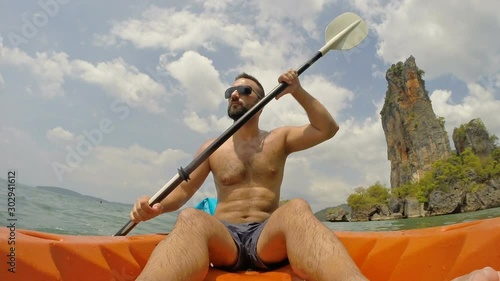 Timelapse of a young adventurer man on a kayak exploring beach of Thailand