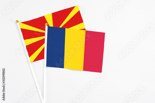 Chad and Macedonia stick flags on white background. High quality fabric, miniature national flag. Peaceful global concept.White floor for copy space.