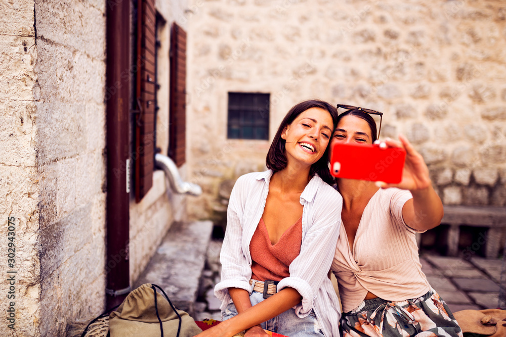 Girls using phone to make selfie