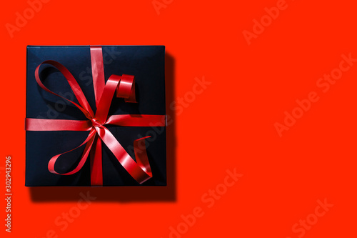 Online shopping of China, 1singles day sale concept. Top view of christmas boxes with red ribbon on red background with copy space photo