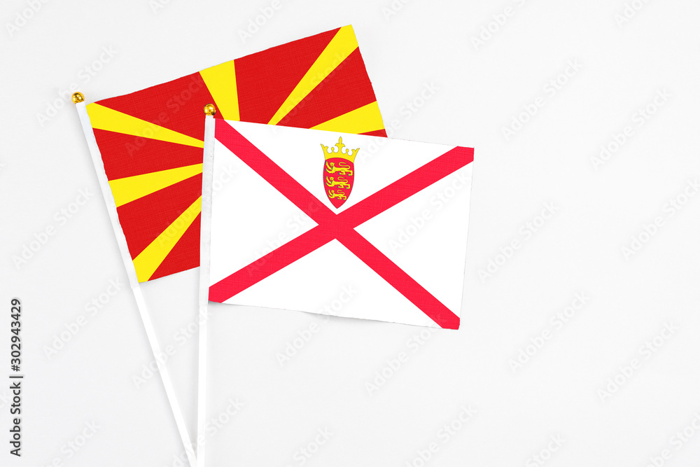 Jersey and Macedonia stick flags on white background. High quality fabric, miniature national flag. Peaceful global concept.White floor for copy space. Jersey and Macedonia stick flags on white background. High quality fabric, miniature national flag. Peaceful global concept.White floor for copy space.