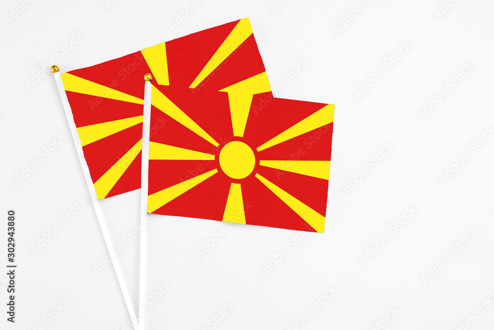 Macedonia and Macedonia stick flags on white background. High quality fabric, miniature national flag. Peaceful global concept.White floor for copy space.