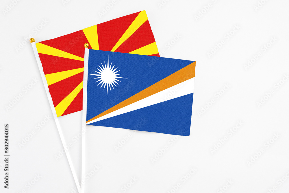 Marshall Islands and Macedonia stick flags on white background. High quality fabric, miniature national flag. Peaceful global concept.White floor for copy space. Marshall Islands and Macedonia stick flags on white background. High quality fabric, miniature national flag. Peaceful global concept.White floor for copy space.