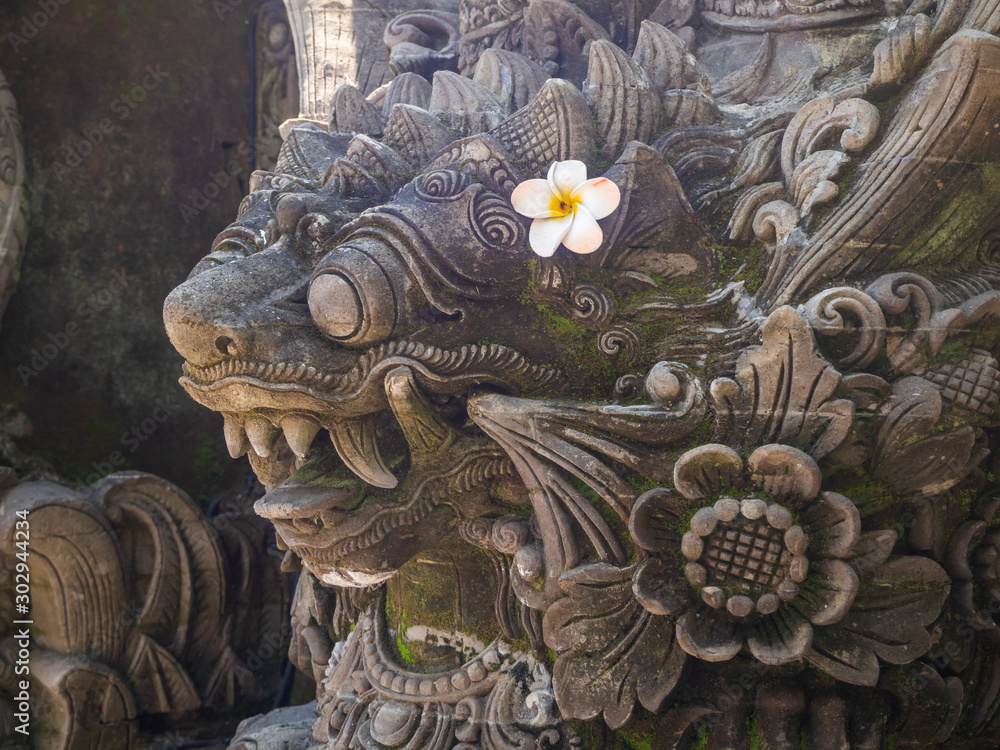 Fototapeta premium Temple with statues covered with moss on the island of Bali