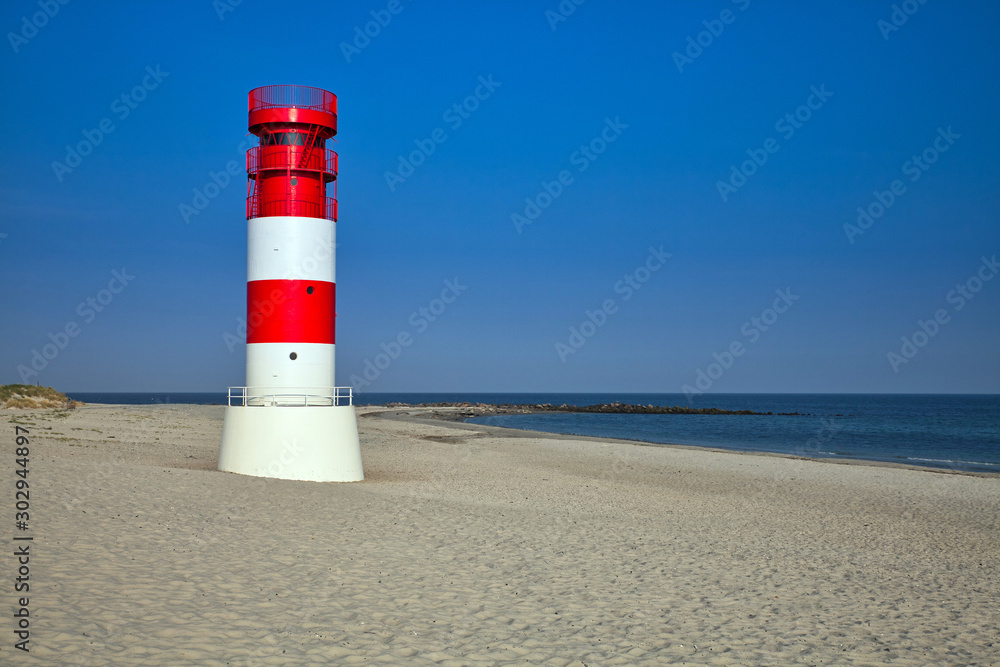 lighthouse on düne with an empty beach