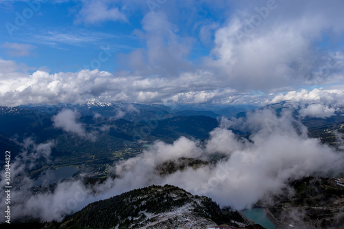 Clouds, blue sky, mountains, snow and glacial ponds, BC, Canada