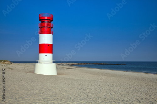 lighthouse on düne with an empty beach