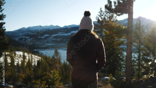 Woman Hiking by Beautiful Mountain Lake in Winter