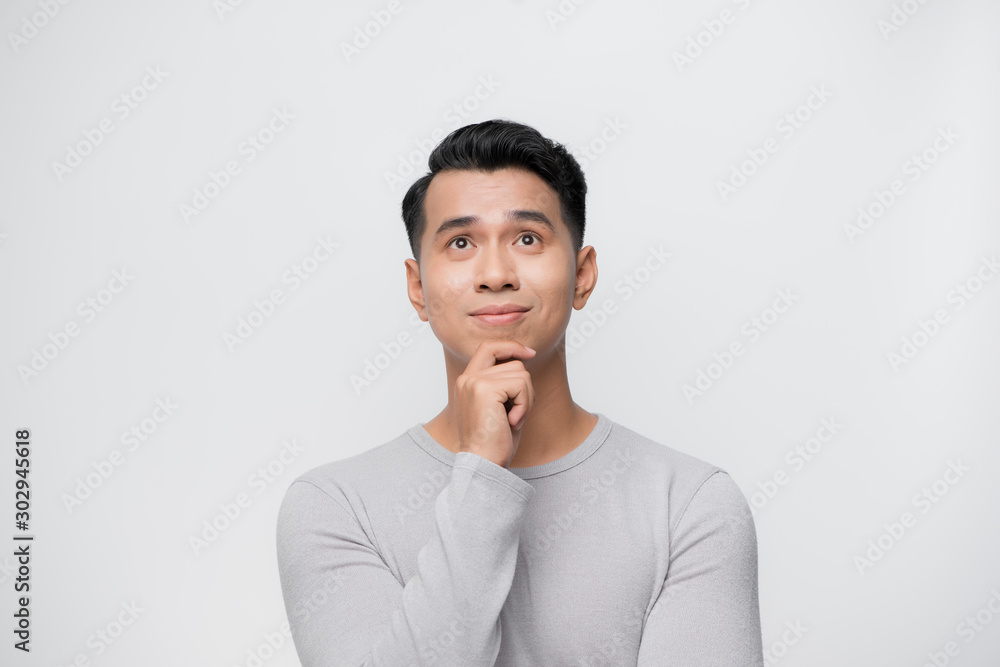Thinking young Asian man isolated on white background. Thinking young Asian man isolated on white background.