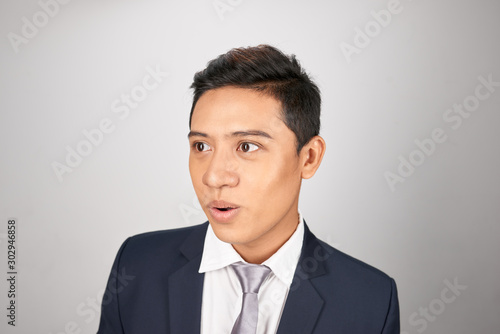 Wow and surprised Asian entrepreneur businessman on white background © makistock