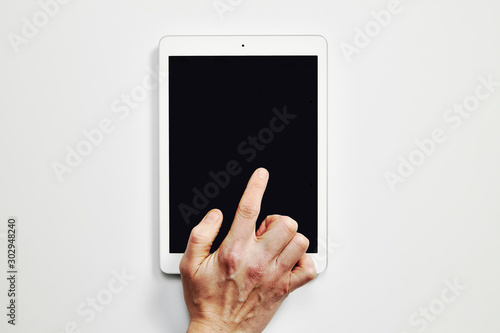 Overhead shot of Ipad with finger