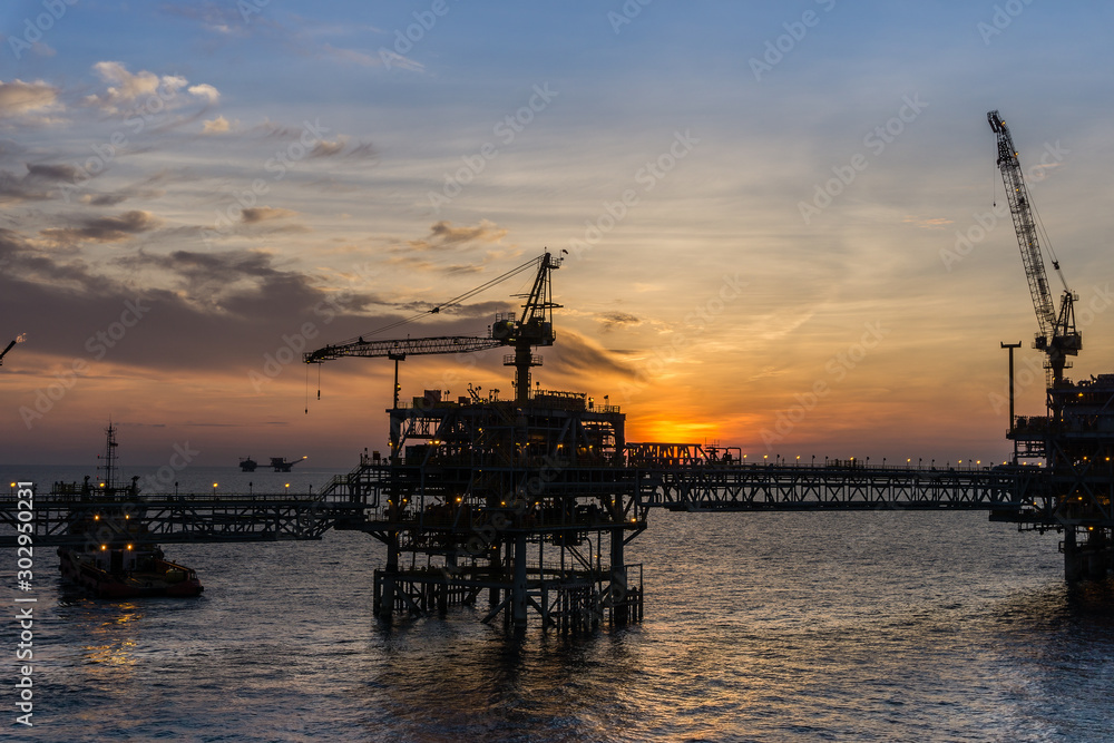 Blurry image of oil production platform during sunset
