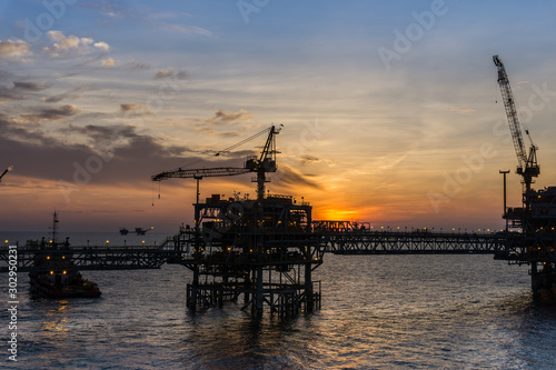 Blurry image of oil production platform during sunset
