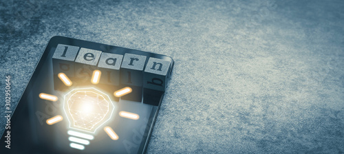 Cube letter word of Learn with tablet and light bulb and futuristic icon. Photo concept of online course of business and education, academic and literature long distance e-learning photo