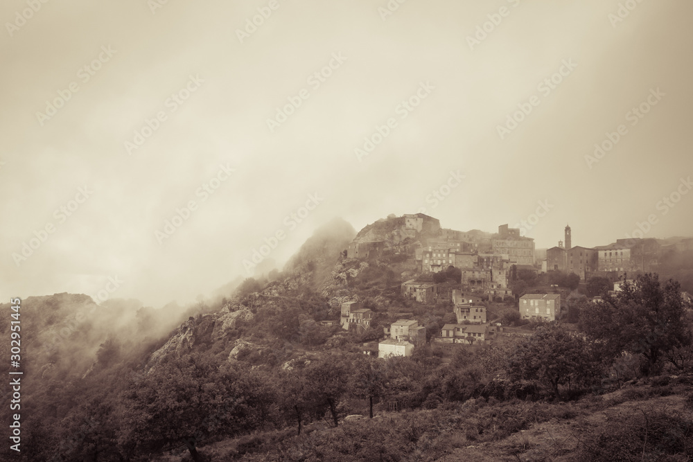 Village of Speloncato in Corsica shrouded in mist Village of Speloncato in Corsica shrouded in mist
