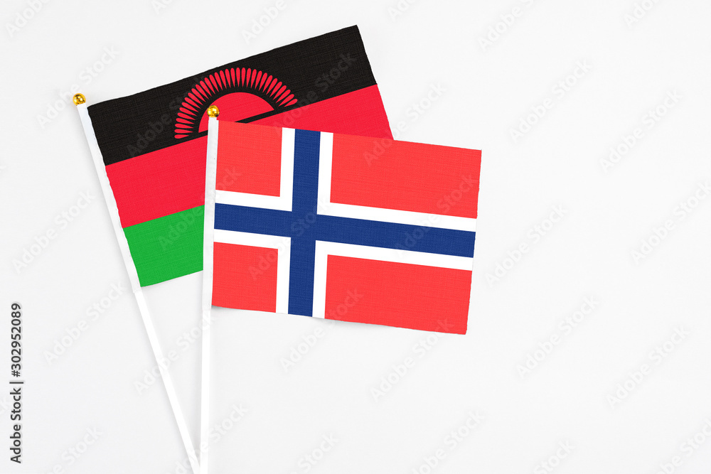 Bouvet Islands and Malawi stick flags on white background. High quality fabric, miniature national flag. Peaceful global concept.White floor for copy space. Bouvet Islands and Malawi stick flags on white background. High quality fabric, miniature national flag. Peaceful global concept.White floor for copy space.