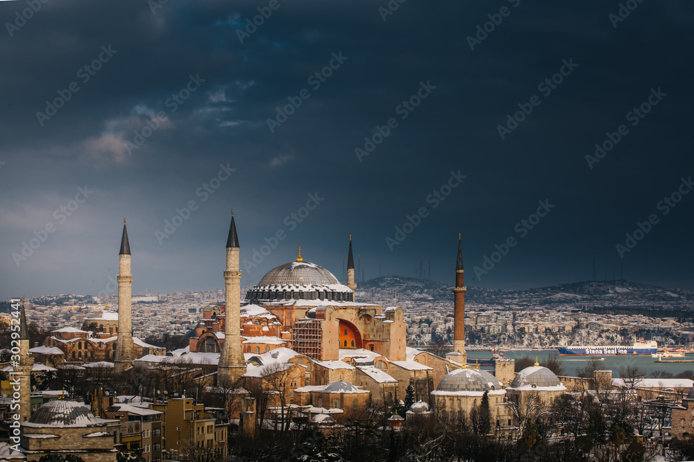 Obraz premium Snowy day in Sultanahmet Square. View of HAGIA SOPHIA. Istanbul, Turkey.Hagia Sophia (Turkish: Ayasofya), Istanbul, Turkey.