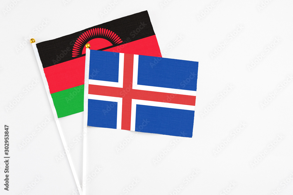 Iceland and Malawi stick flags on white background. High quality fabric, miniature national flag. Peaceful global concept.White floor for copy space.