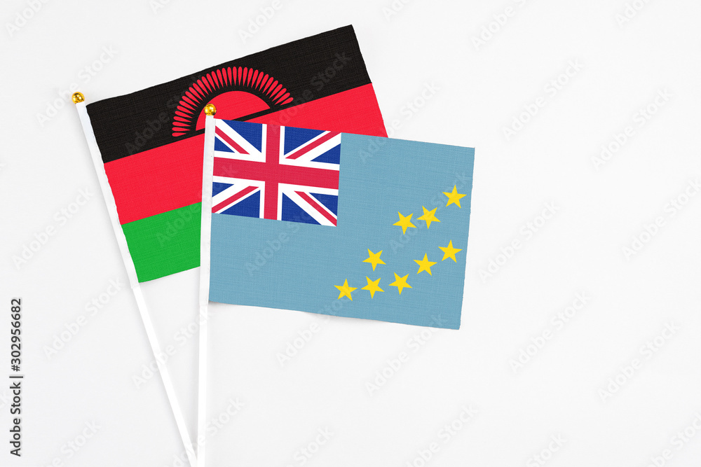 Tuvalu and Malawi stick flags on white background. High quality fabric, miniature national flag. Peaceful global concept.White floor for copy space. Tuvalu and Malawi stick flags on white background. High quality fabric, miniature national flag. Peaceful global concept.White floor for copy space.
