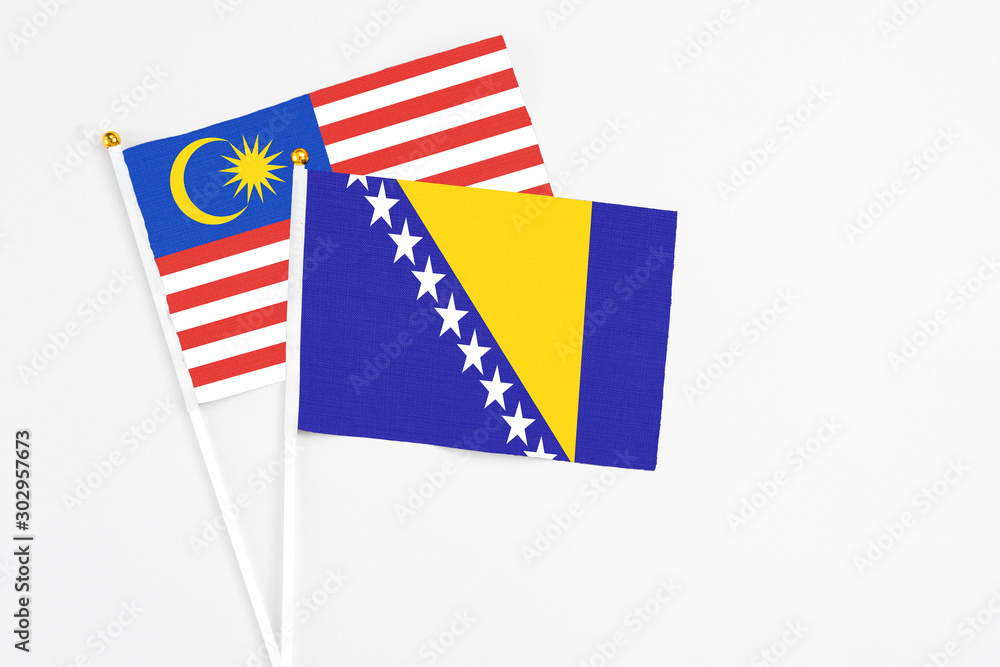 Bosnia Herzegovina and Malaysia stick flags on white background. High quality fabric, miniature national flag. Peaceful global concept.White floor for copy space. Bosnia Herzegovina and Malaysia stick flags on white background. High quality fabric, miniature national flag. Peaceful global concept.White floor for copy space.