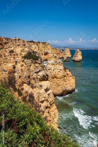 Coastal cliffs and sea stacks near Ponta da Piedate, Lagos, Portugal. photo