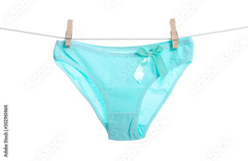 Green female panties clothespins rope on white background isolation