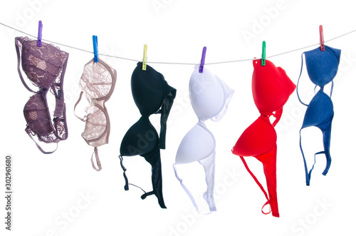 Fotografie Female bras on clothespins rope on white background isolation