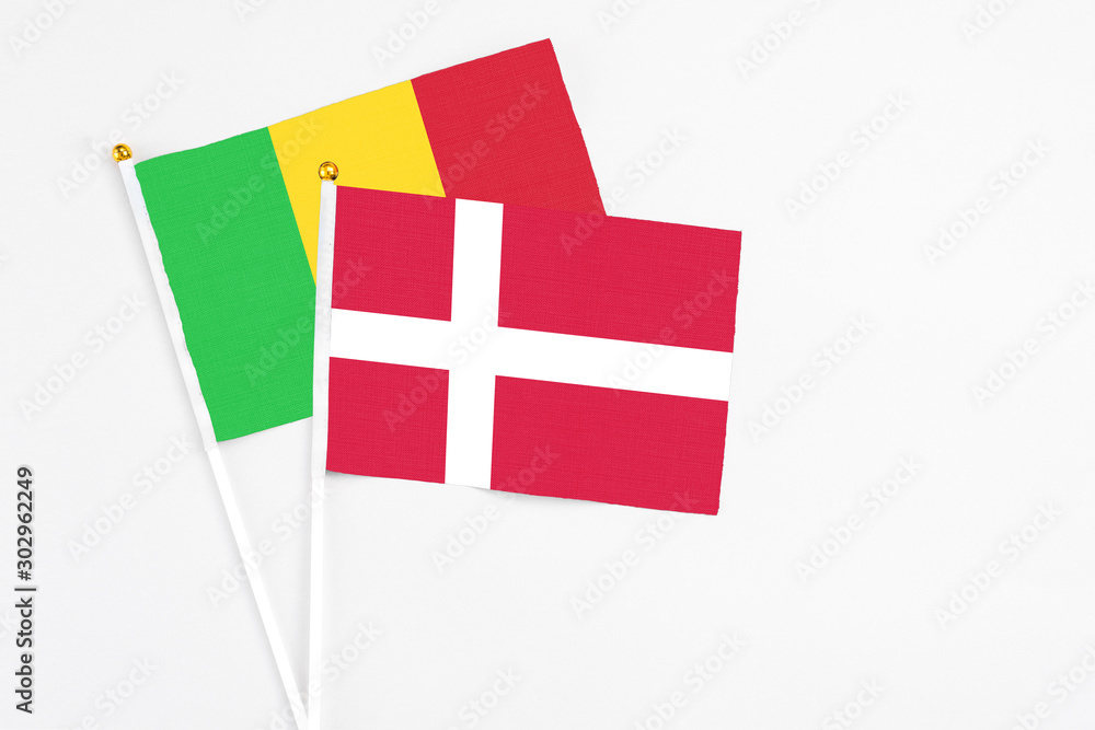 Denmark and Mali stick flags on white background. High quality fabric, miniature national flag. Peaceful global concept.White floor for copy space.