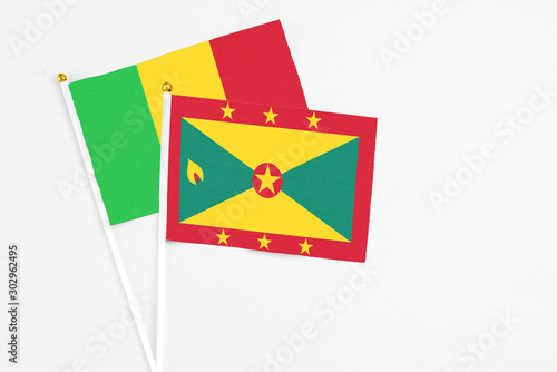 Wallpaper Mural Grenada and Mali stick flags on white background. High quality fabric, miniature national flag. Peaceful global concept.White floor for copy space. Torontodigital.ca