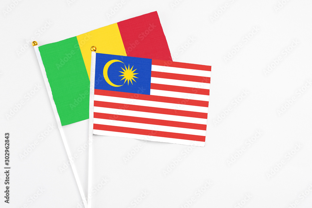 Malaysia and Mali stick flags on white background. High quality fabric, miniature national flag. Peaceful global concept.White floor for copy space. Malaysia and Mali stick flags on white background. High quality fabric, miniature national flag. Peaceful global concept.White floor for copy space.