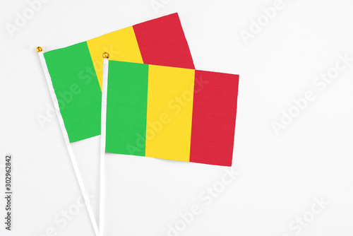Mali and Mali stick flags on white background. High quality fabric, miniature national flag. Peaceful global concept.White floor for copy space.