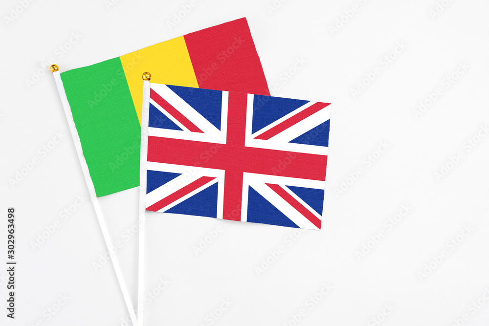 United Kingdom and Mali stick flags on white background. High quality fabric, miniature national flag. Peaceful global concept.White floor for copy space. United Kingdom and Mali stick flags on white background. High quality fabric, miniature national flag. Peaceful global concept.White floor for copy space.
