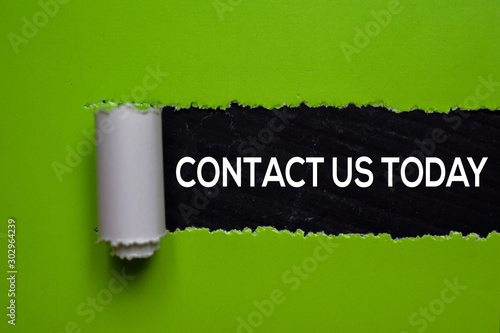 Contact Us Today Text written in torn paper photo