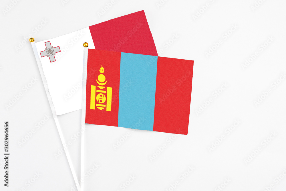 Mongolia and Malta stick flags on white background. High quality fabric, miniature national flag. Peaceful global concept.White floor for copy space. Mongolia and Malta stick flags on white background. High quality fabric, miniature national flag. Peaceful global concept.White floor for copy space.