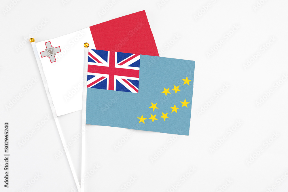 Tuvalu and Malta stick flags on white background. High quality fabric, miniature national flag. Peaceful global concept.White floor for copy space. Tuvalu and Malta stick flags on white background. High quality fabric, miniature national flag. Peaceful global concept.White floor for copy space.