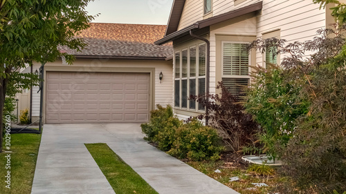 Panorama frame Concrete driveway leading to a double garage