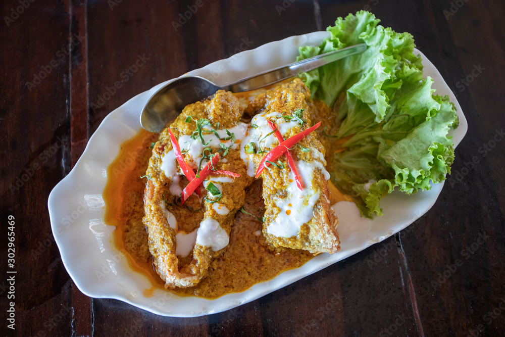 Fish curry on a white plate Fish curry on a white plate