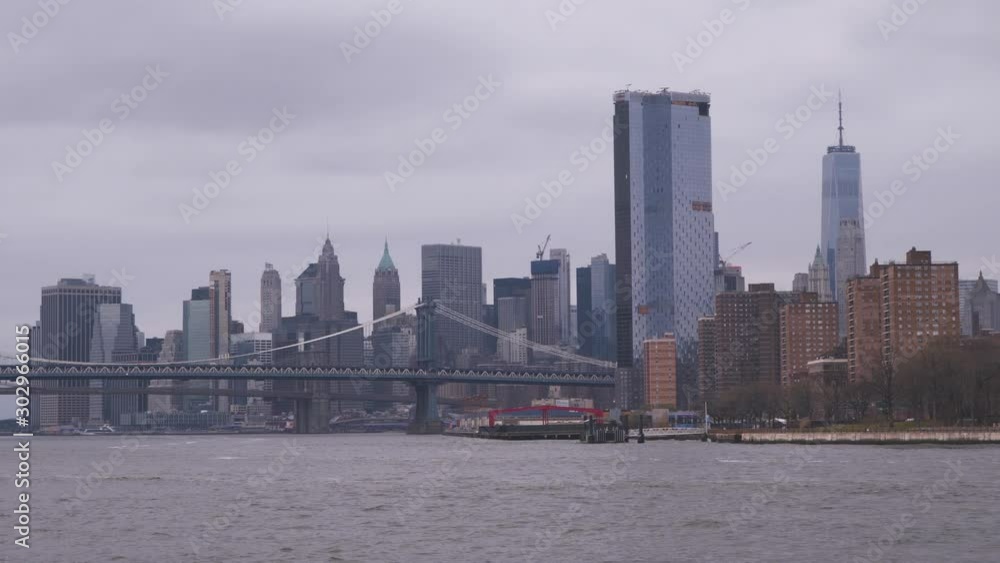 New York City skyline with One World Trade Center and Manhattan Bridge. View from East river New York City skyline with One World Trade Center and Manhattan Bridge. View from East river