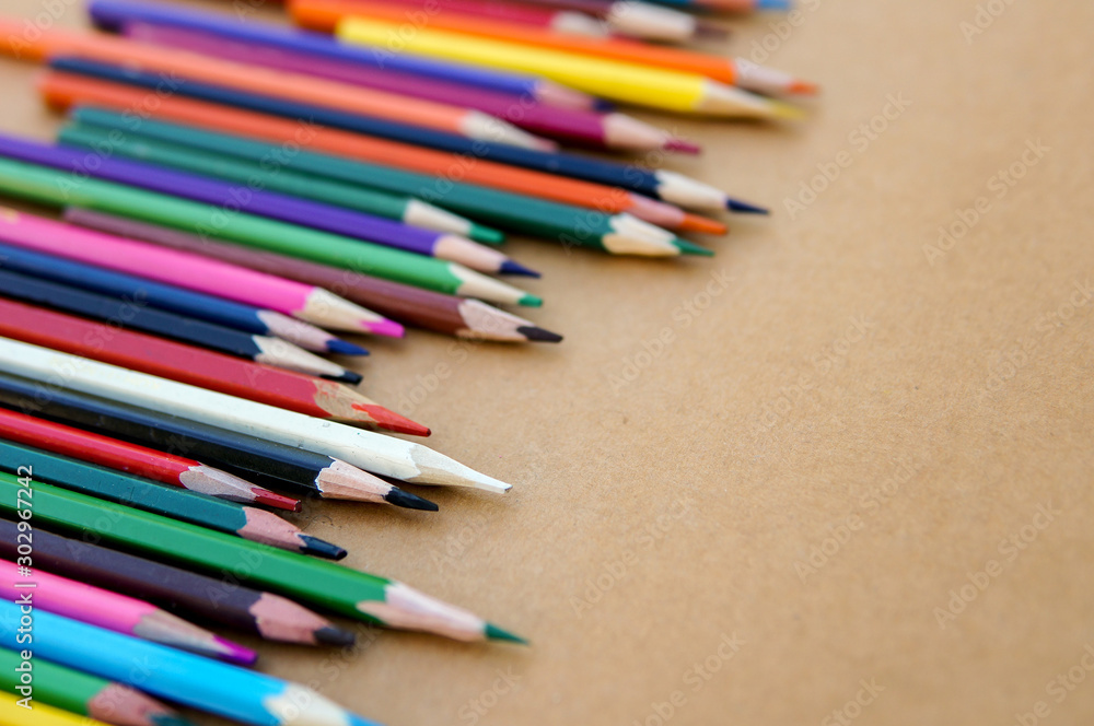 Multicolor sharpened pencils isolated on paper background in a row and messy Multicolor sharpened pencils isolated on paper background in a row and messy