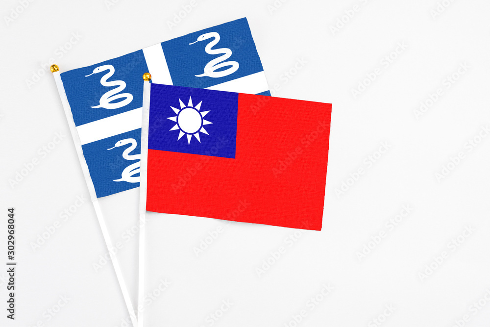 Taiwan and Martinique stick flags on white background. High quality fabric, miniature national flag. Peaceful global concept.White floor for copy space. Taiwan and Martinique stick flags on white background. High quality fabric, miniature national flag. Peaceful global concept.White floor for copy space.