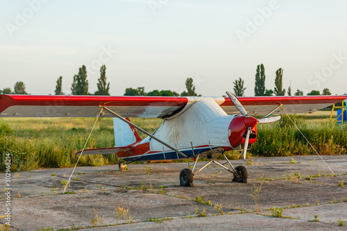 field with plane flying over it