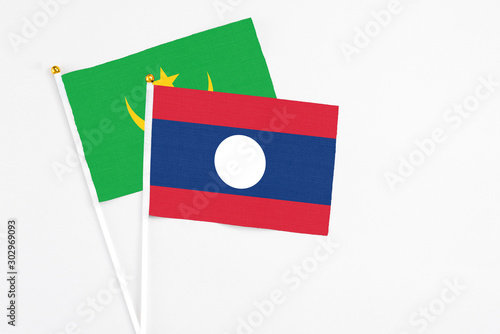 Free Download Laos and Mauritania stick flags on white background. High quality fabric, miniature national flag. Peaceful global concept.White floor for copy space. - GFXLoad