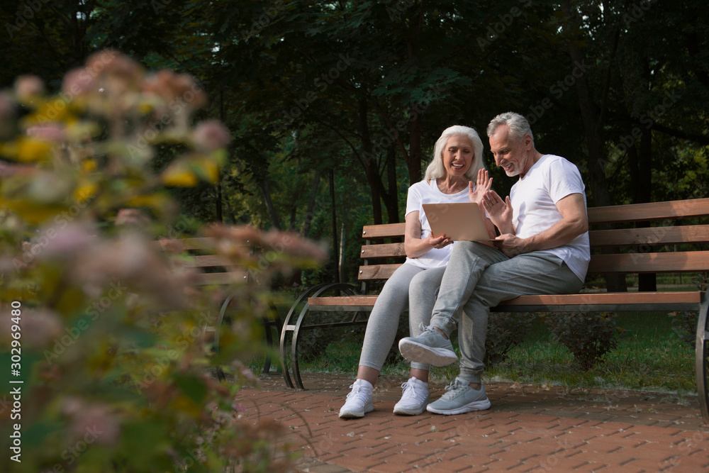 Happy mature couple having video call stock photo Happy mature couple having video call stock photo