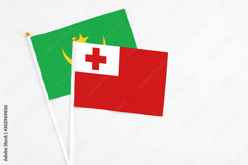 Tonga and Mauritania stick flags on white background. High quality fabric, miniature national flag. Peaceful global concept.White floor for copy space. Tonga and Mauritania stick flags on white background. High quality fabric, miniature national flag. Peaceful global concept.White floor for copy space.