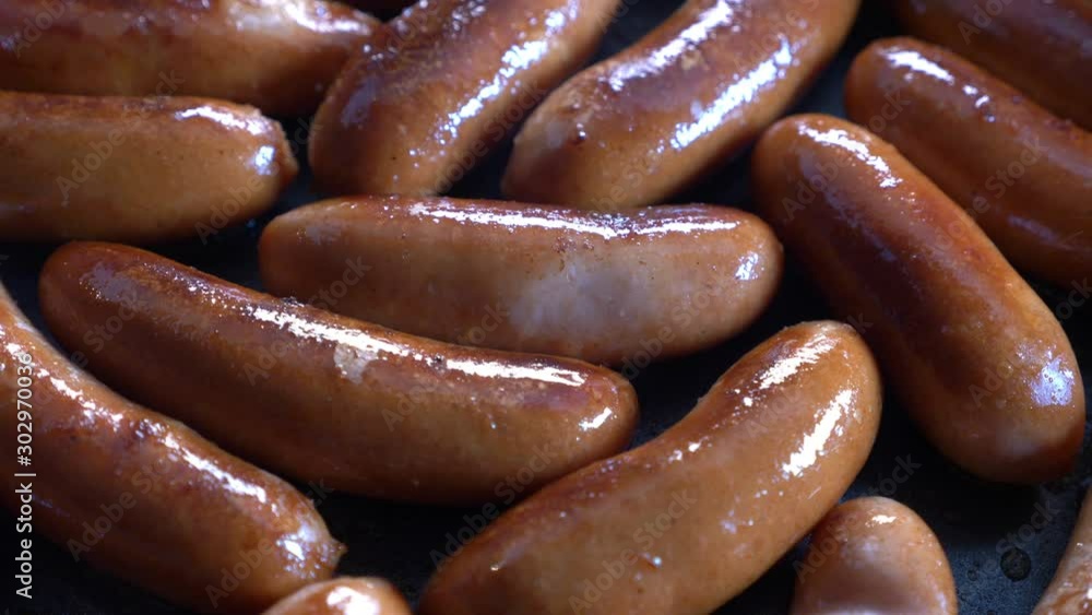 Pork sausages cooking in frying pan Pork sausages cooking in frying pan