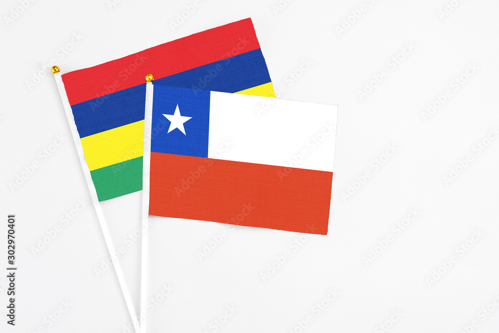 Chile and Mauritius stick flags on white background. High quality fabric, miniature national flag. Peaceful global concept.White floor for copy space. Chile and Mauritius stick flags on white background. High quality fabric, miniature national flag. Peaceful global concept.White floor for copy space.