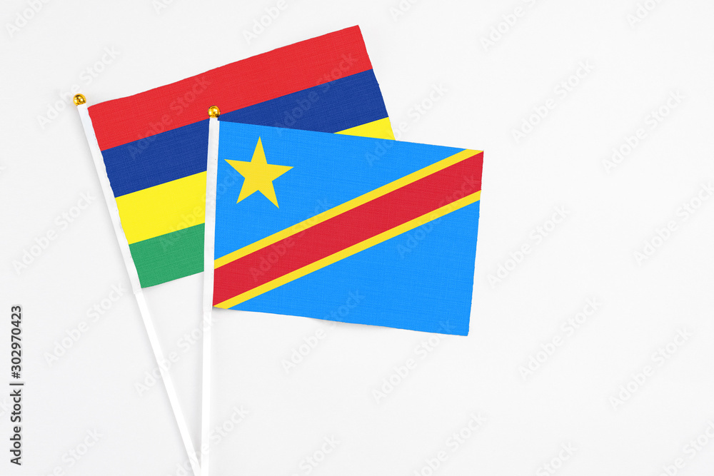 Congo and Mauritius stick flags on white background. High quality fabric, miniature national flag. Peaceful global concept.White floor for copy space. Congo and Mauritius stick flags on white background. High quality fabric, miniature national flag. Peaceful global concept.White floor for copy space.