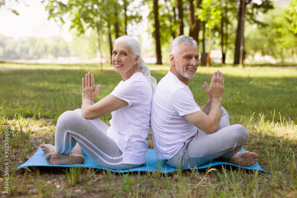 Friendly couple doing meditation together stock photo Friendly couple doing meditation together stock photo
