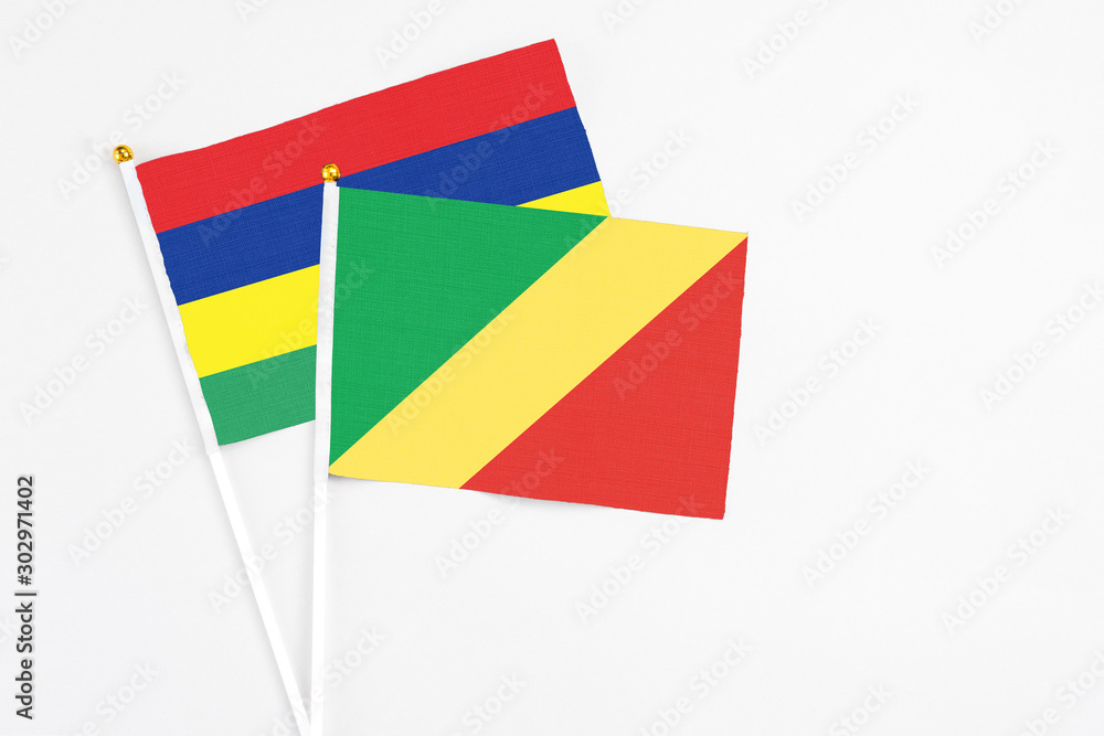 Republic Of The Congo and Mauritius stick flags on white background. High quality fabric, miniature national flag. Peaceful global concept.White floor for copy space. Republic Of The Congo and Mauritius stick flags on white background. High quality fabric, miniature national flag. Peaceful global concept.White floor for copy space.