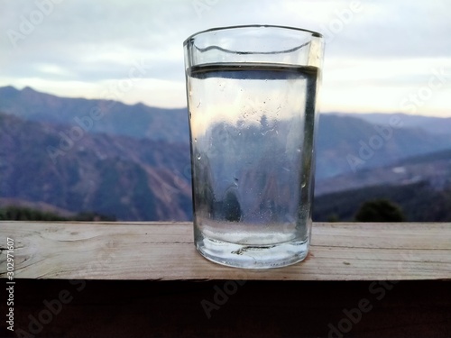 glass of water on background of blue sky